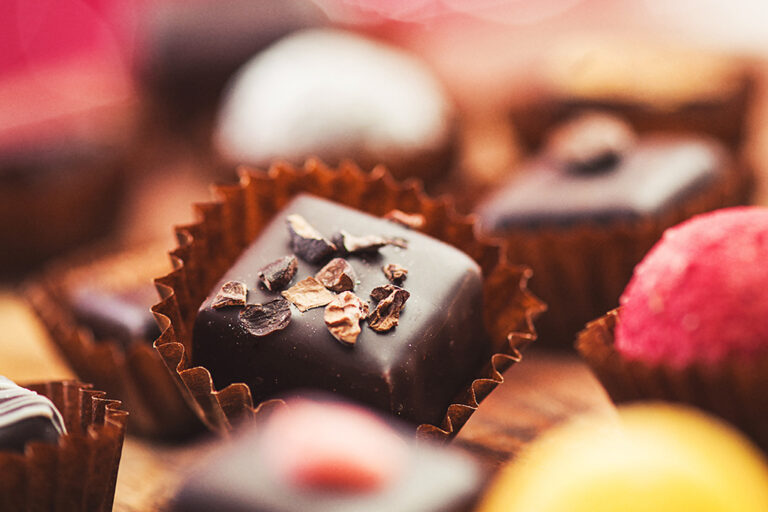 A close up of various chocolate truffles.